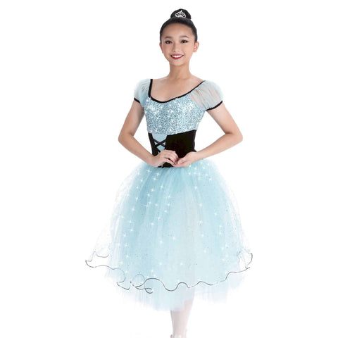 Ballet dancer in a light blue and black dress with sequin details on a white background