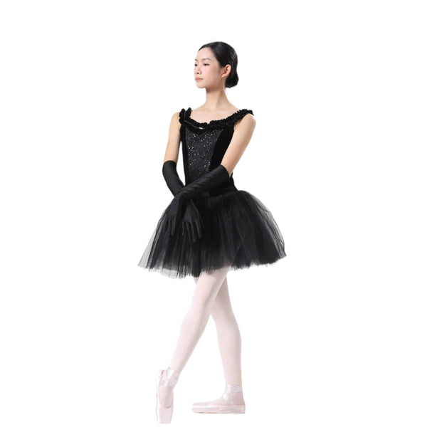 Ballerina in a black tutu with gloves and pink shoes on a white background
