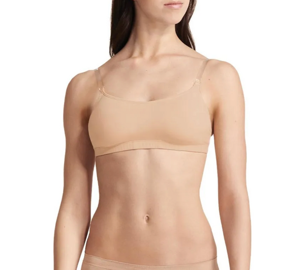 A nude camisole bra with adjustable straps and a built-in bra cup, designed for dancers.