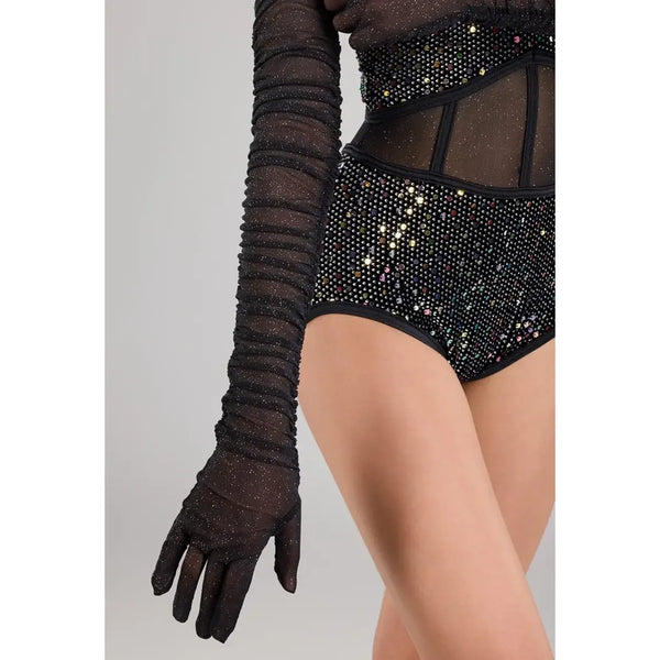 A close-up of a model wearing a black sheer long glove with horizontal ruching and a black embellished bodysuit with rhinestones and mesh panels.