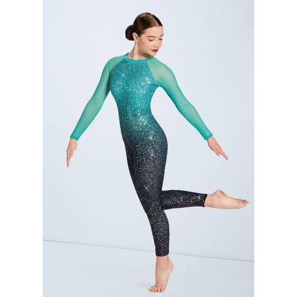 A person wearing a 'Crystallize' Sequin Catsuit with long sleeves and a round neckline, featuring ombré print sequins with a power mesh shoulder and G-hook closure at the back cutout.